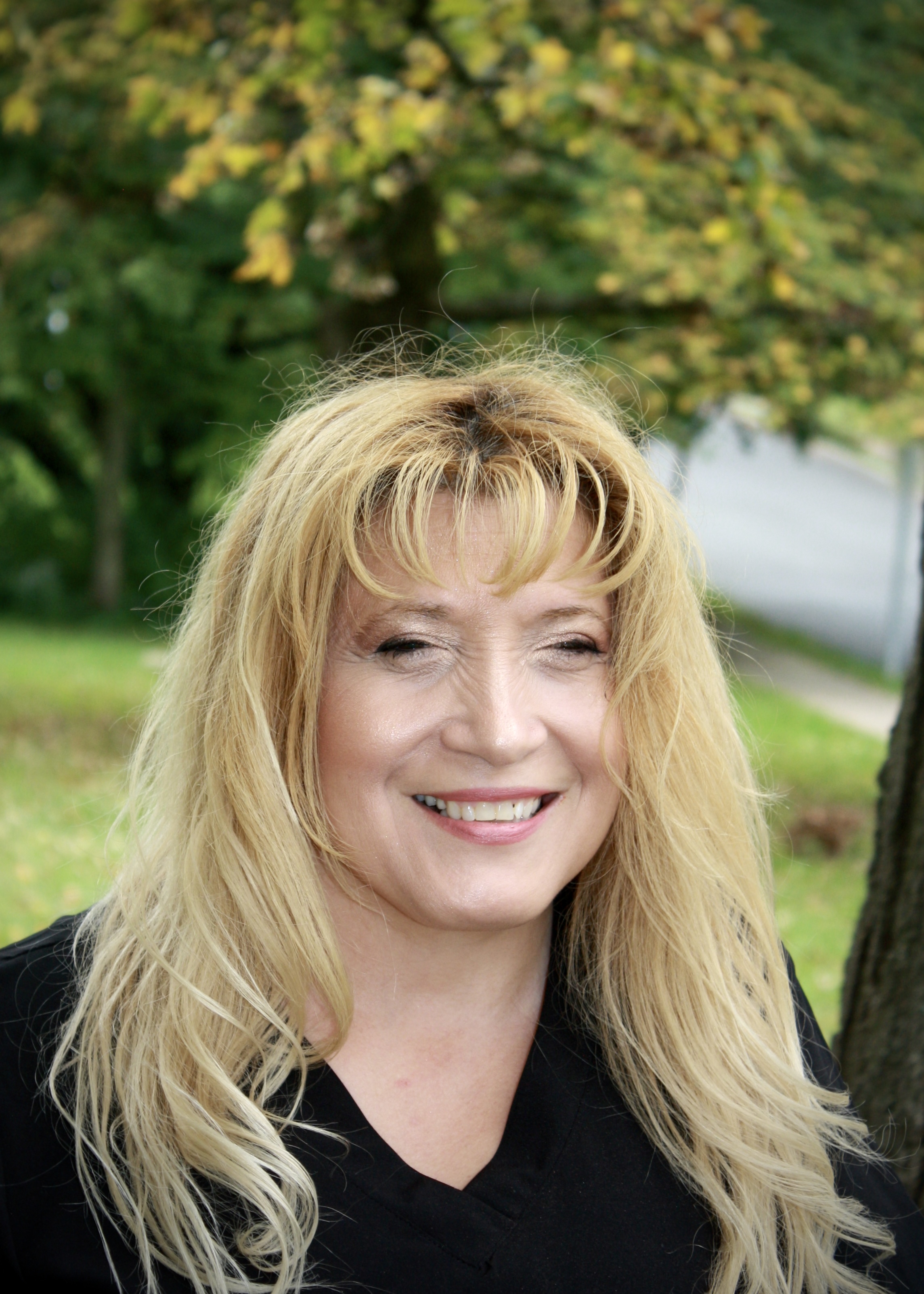 A woman with blonde hair smiling at the camera.
