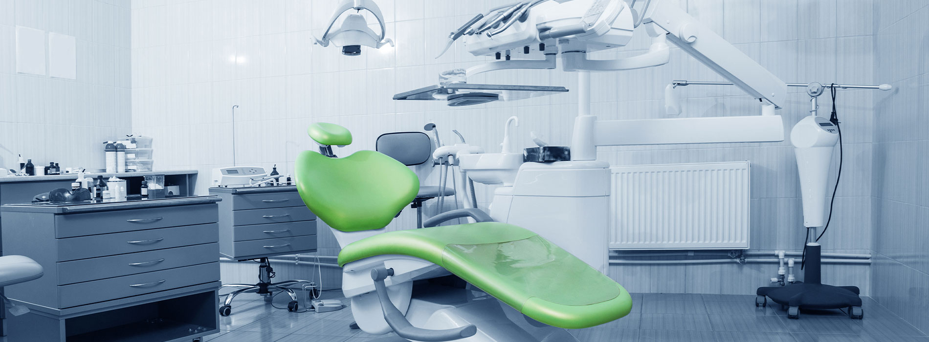 The image shows a dental clinic interior with a modern dental chair, equipment, and a clean environment.