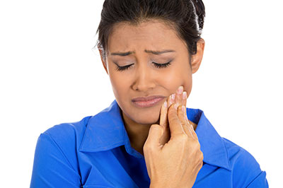 The image depicts a woman with her eyes closed, holding her finger to her nose, seemingly reacting with disbelief or surprise.